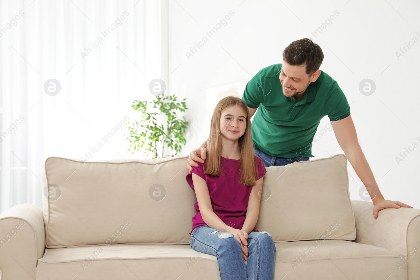 Photo of Father talking with his teenager daughter at home