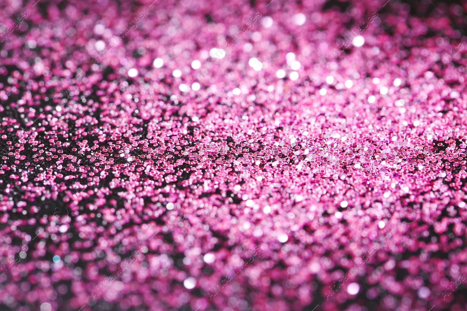 Photo of Pink glitter with bokeh effect on dark background