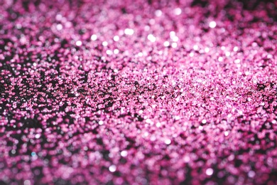 Photo of Pink glitter with bokeh effect on dark background