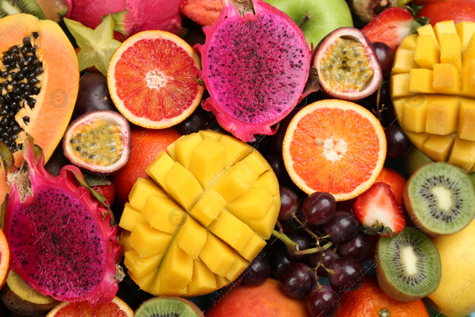 Photo of Many different delicious exotic fruits as background, top view