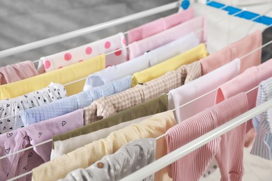 Clean laundry hanging on drying rack, closeup