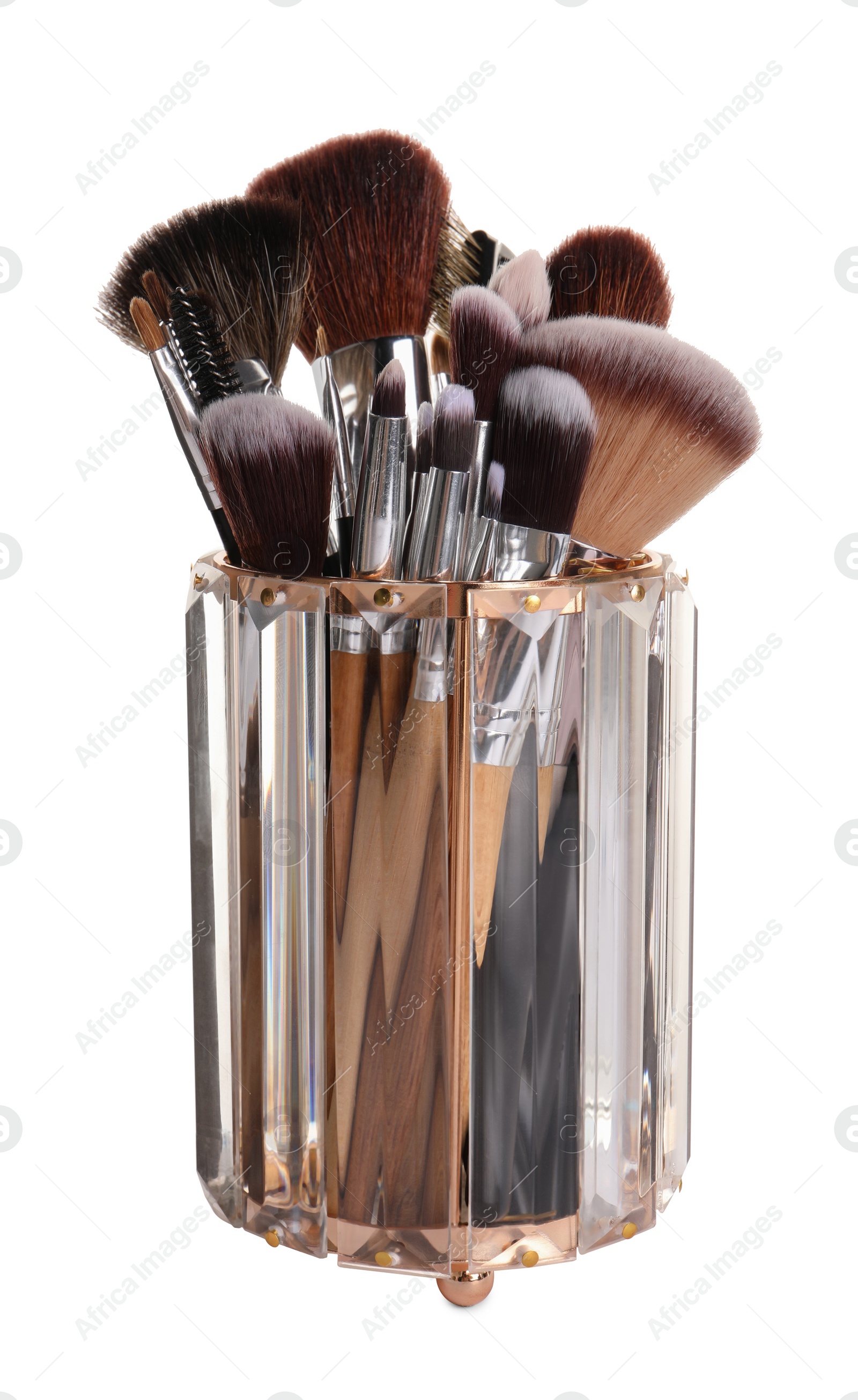 Photo of Glass holder with professional makeup brushes on white background