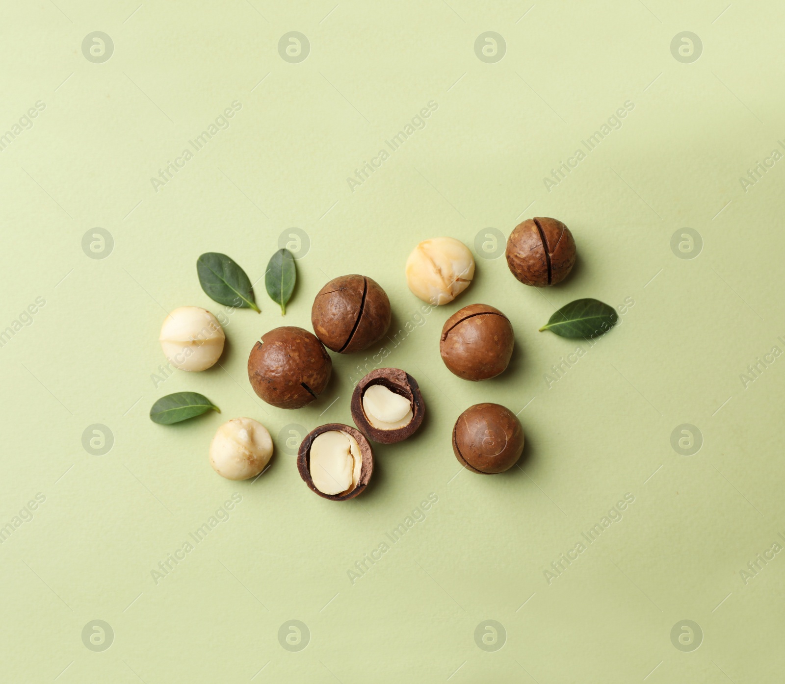 Photo of Flat lay composition with organic Macadamia nuts on color background