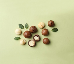 Flat lay composition with organic Macadamia nuts on color background