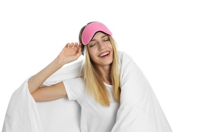 Photo of Young woman in sleeping mask wrapped with soft blanket on white background