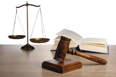 Photo of Law concept. Judge's mallet, scales of justice and open book on wooden table against white background