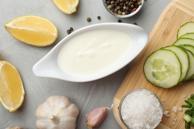 Photo of Flat lay composition with cucumber sauce and ingredients on grey background