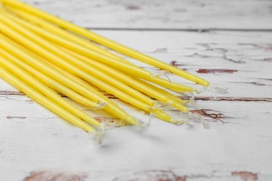 Photo of Church candles on white wooden table, closeup