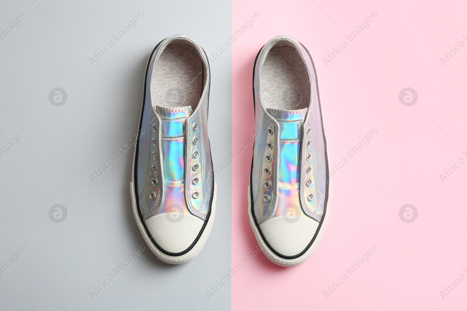 Photo of Stylish sneakers on color background, top view