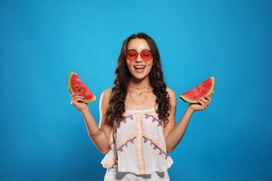 Photo of Beautiful young woman with watermelon on blue background