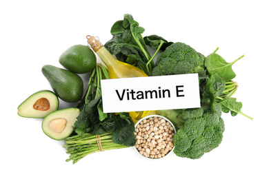Card with phrase Vitamin E and different products on white background, top view