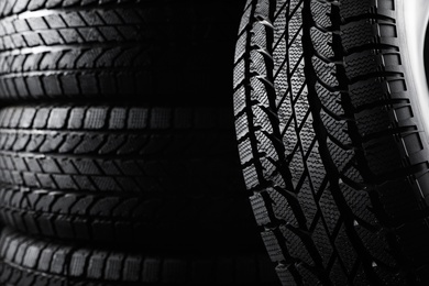 Photo of Winter tires as background, closeup. Car maintenance