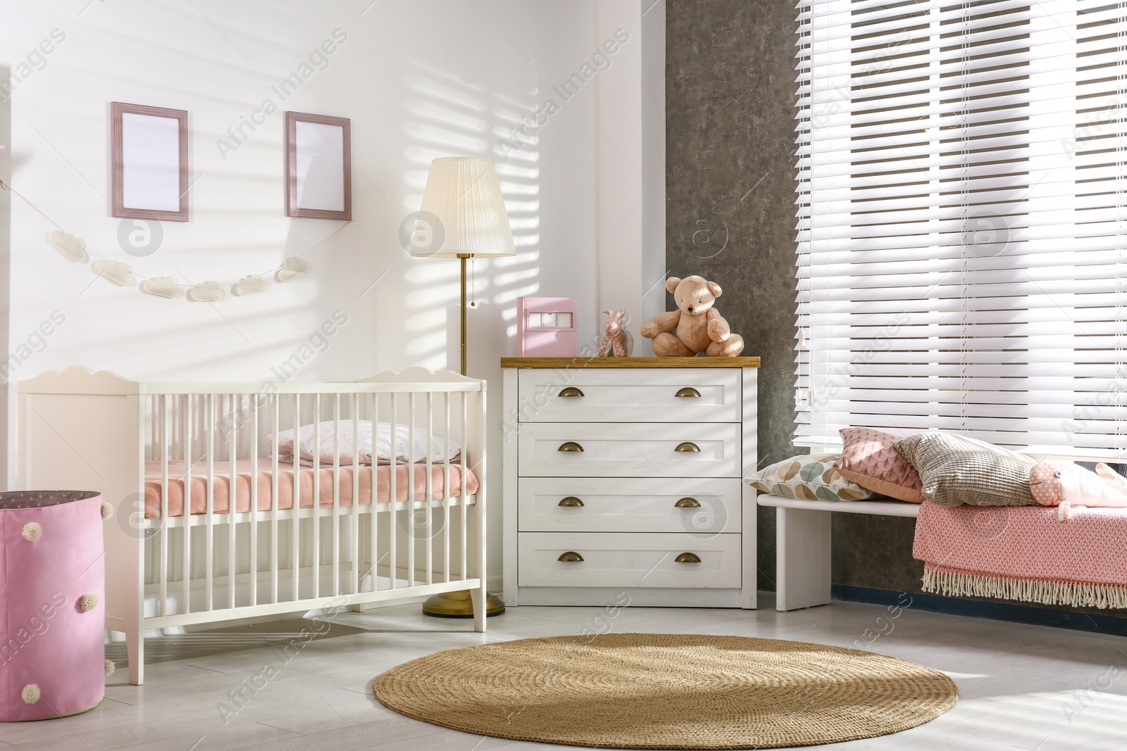 Photo of Cozy baby room interior with comfortable crib