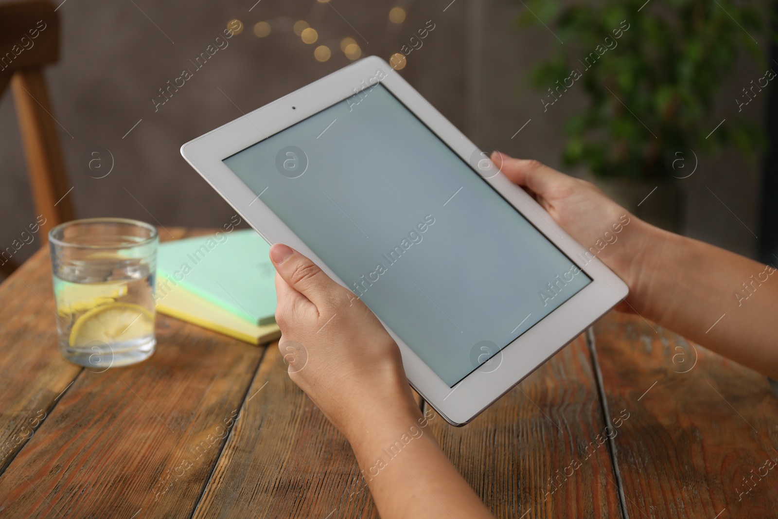 Photo of Woman using new modern tablet indoors, closeup