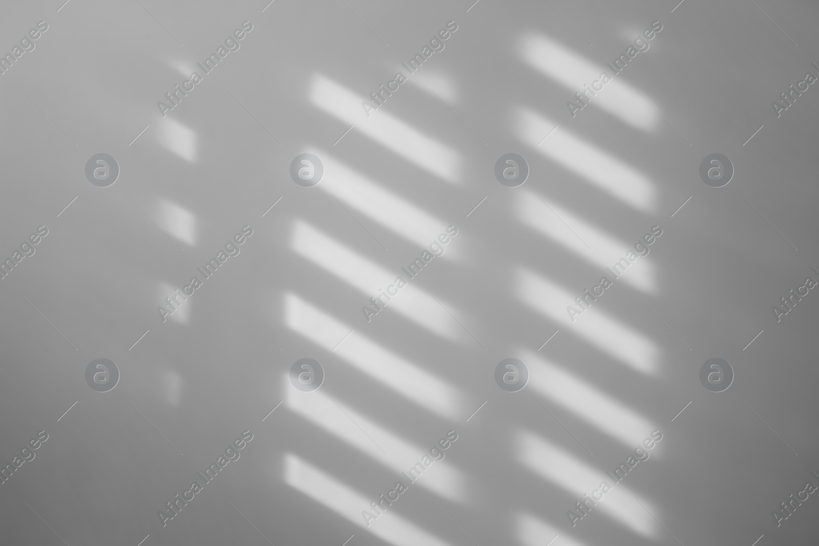 Image of Light and shadows falling on white wall