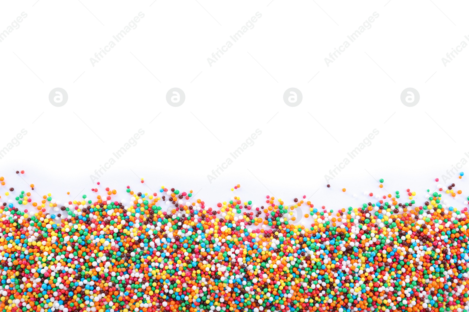 Photo of Colorful sprinkles on white background, top view. Confectionery decor