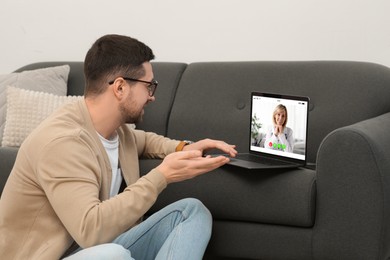 Image of Online medical consultation. Man having video chat with doctor via laptop at home, closeup