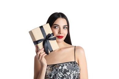 Woman in party dress holding Christmas gift on white background