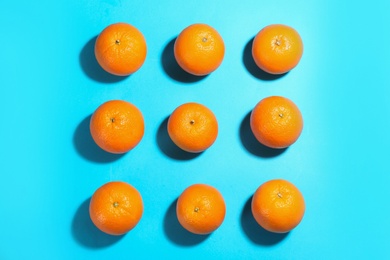 Photo of Flat lay composition with fresh ripe oranges on turquoise background