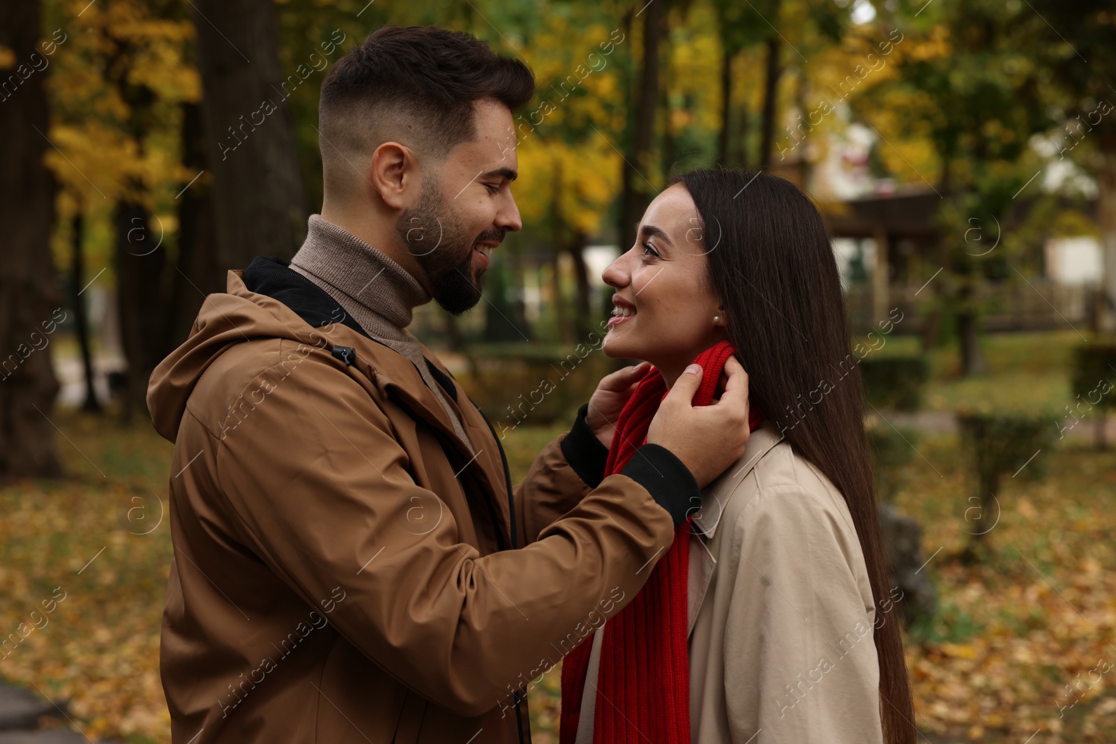 Photo of Happy young couple spending time together in autumn park