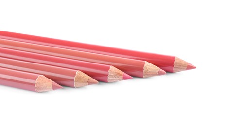 Many different lip pencils on white background, closeup. Cosmetic product