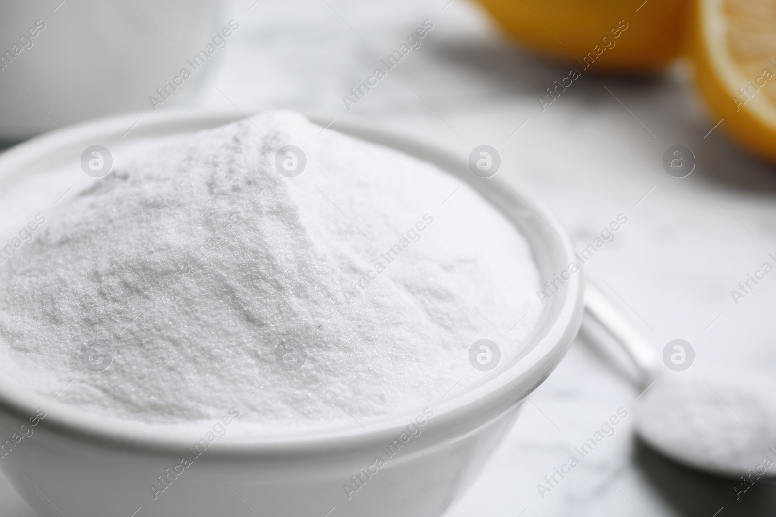 Photo of Baking soda on white marble table, closeup