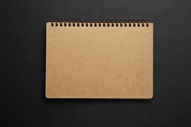 One notebook on black background, top view