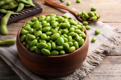 Bowl of delicious edamame beans on wooden table