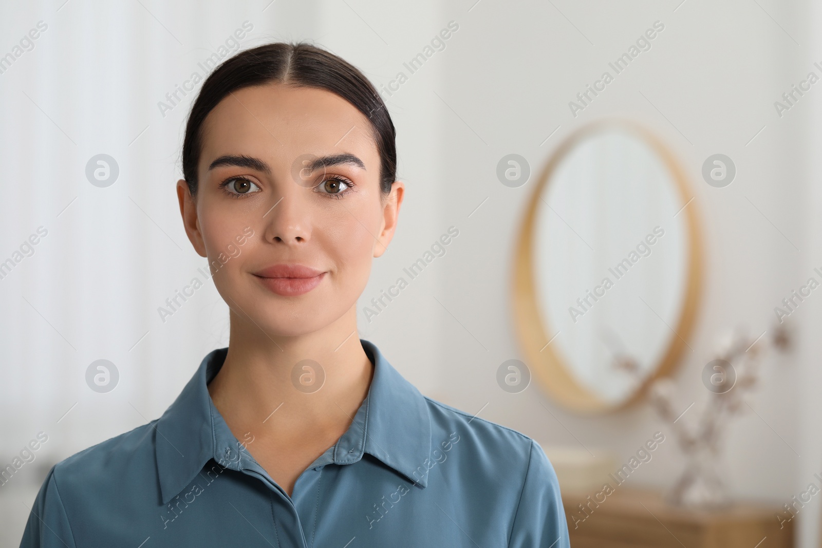 Photo of Portrait of beautiful young woman on blurred background. Space for text