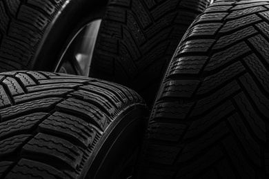 Photo of Set of wheels with winter tires as background, closeup