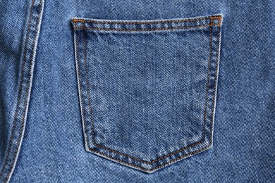 Light blue jeans with back pocket as background, closeup