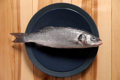 Fresh raw fish on wooden table, top view