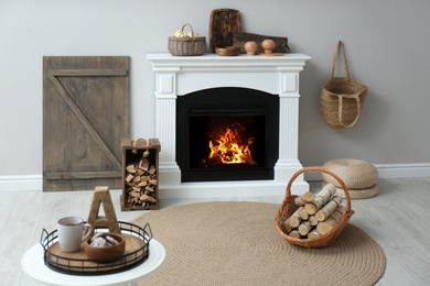 Photo of Cozy living room interior with firewood and white fireplace