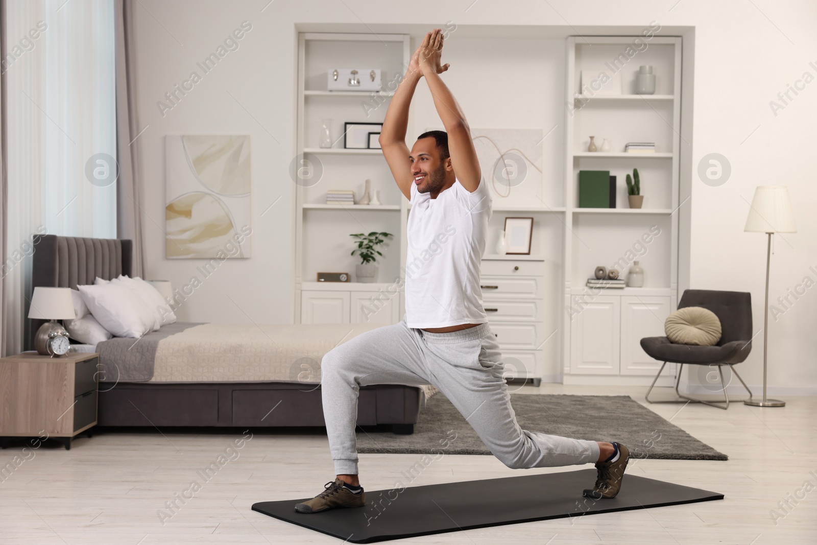 Photo of Man doing morning exercise on fitness mat at home