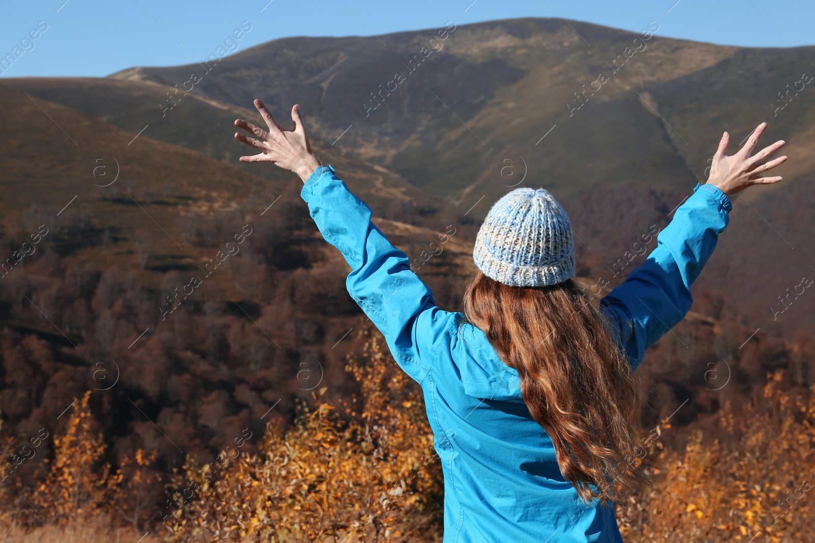 Photo of Woman in warm clothes enjoying mountain landscape