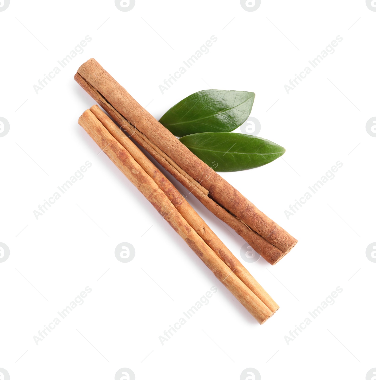 Photo of Cinnamon sticks and green leaves isolated on white, top view