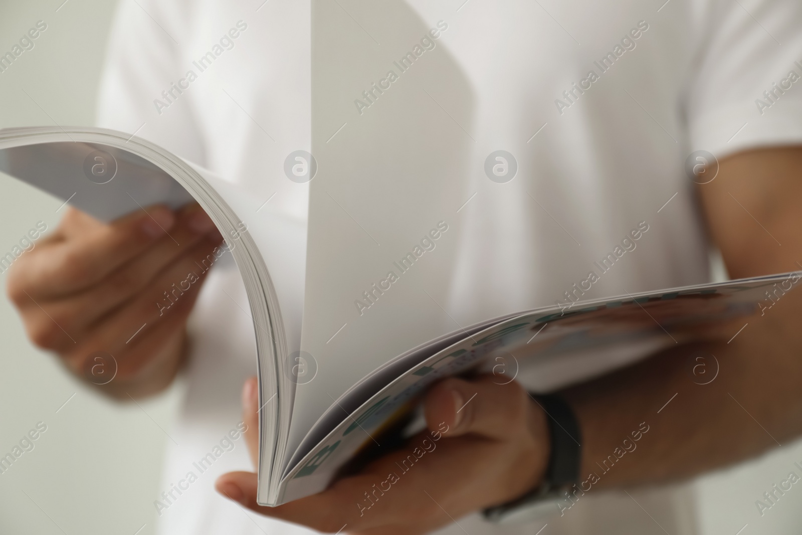 Photo of Closeup view of man reading healthy food magazine