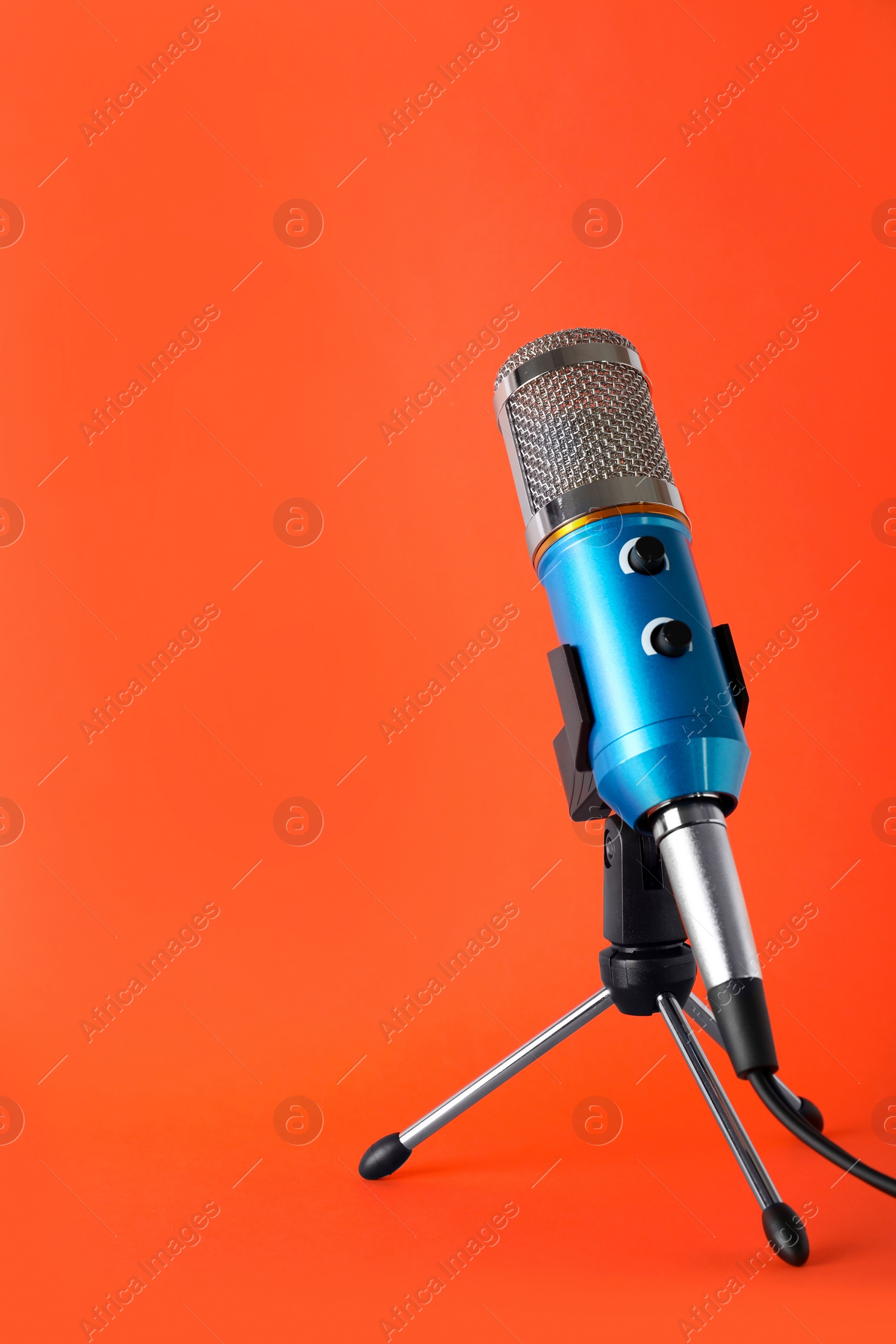 Photo of Condenser microphone on color background, space for text