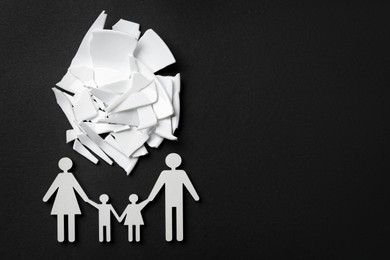 Photo of Divorce concept. Broken plate pieces and paper cutout of family on black background, flat lay with space for text