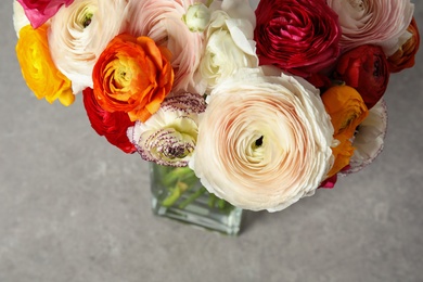 Photo of Beautiful spring ranunculus flowers in vase on table