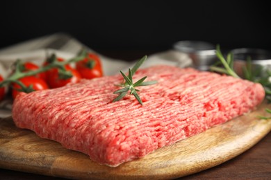 Photo of Board with raw fresh minced meat on wooden table, closeup