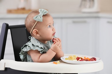 Cute little girl eating healthy food at home