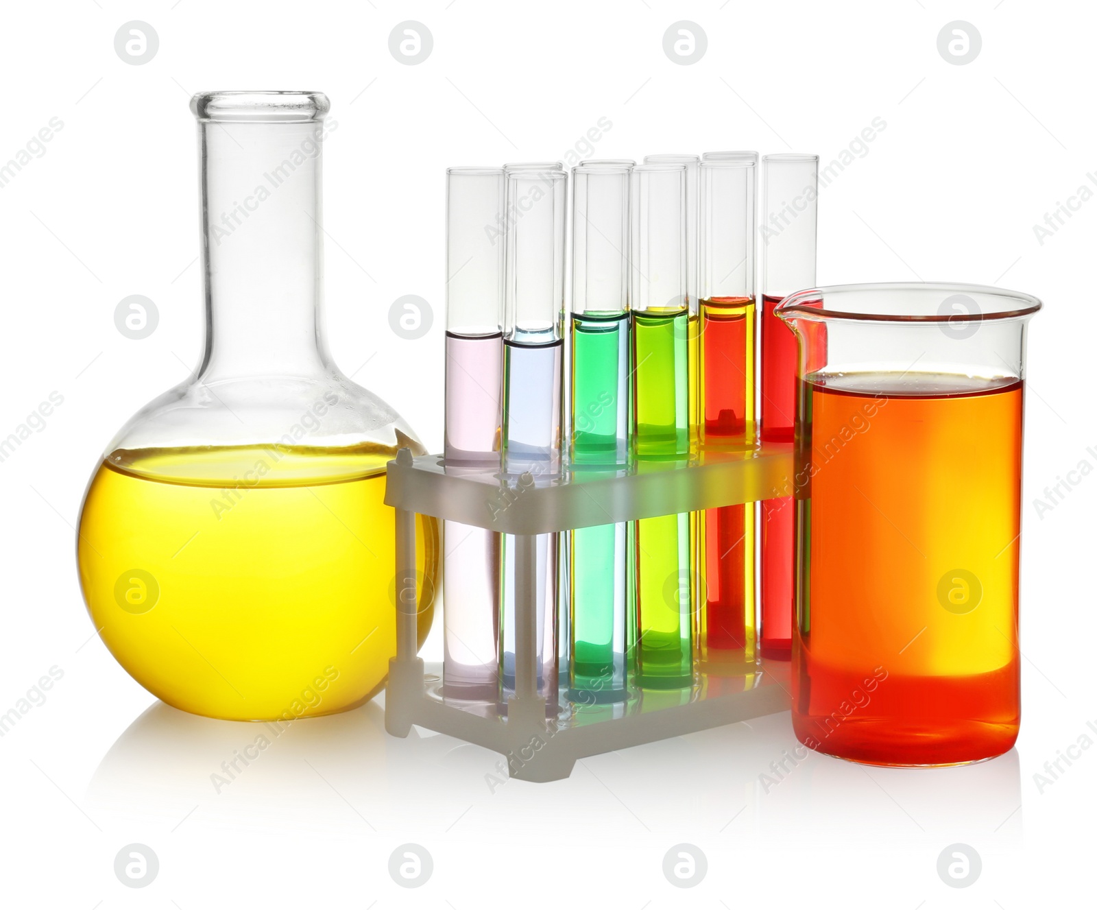 Photo of Laboratory glassware with colorful liquids on white background