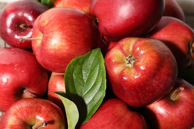 Photo of Many fresh apples and leaves as background, above view