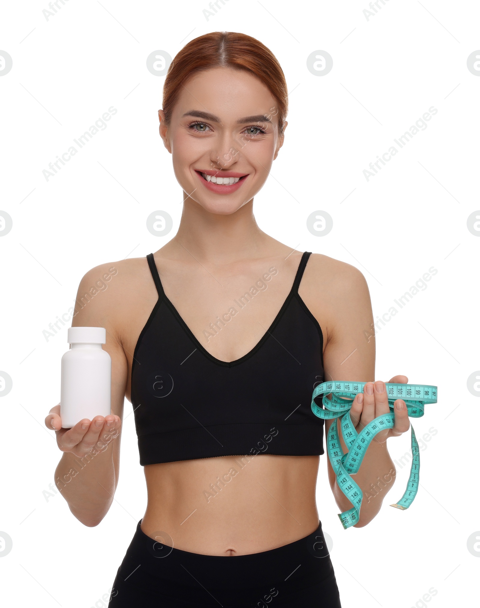 Photo of Happy young woman with bottle of pills and measuring tape on white background. Weight loss