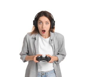 Surprised woman in headphones playing video game with controller on white background