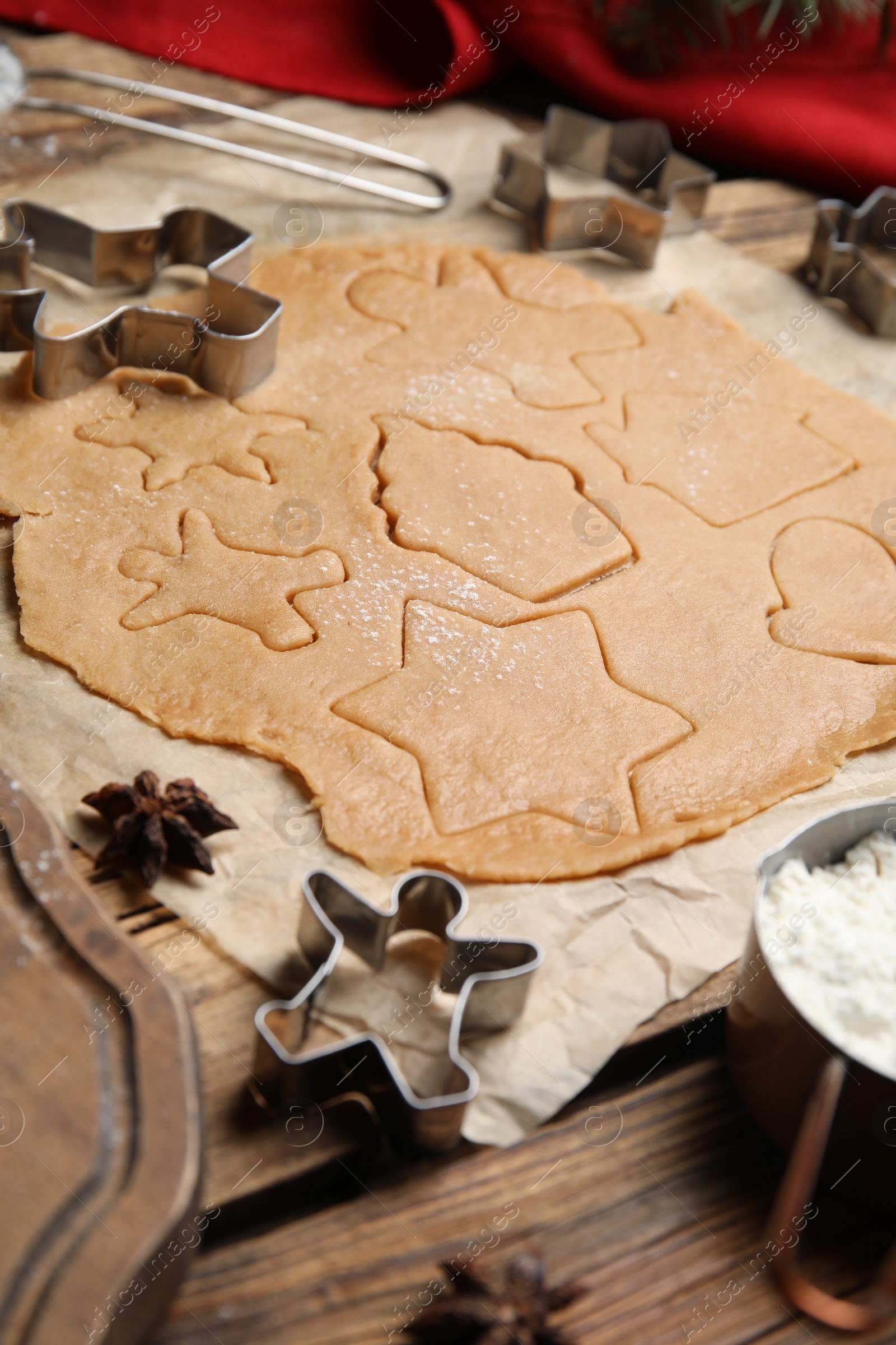 Photo of Making homemade Christmas cookies. Dough and cutters on table, closeup