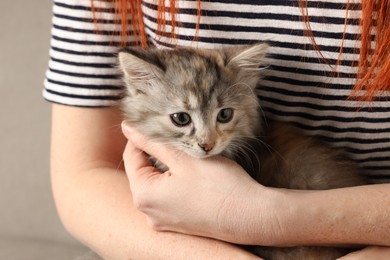 Woman with cute fluffy kitten, closeup view