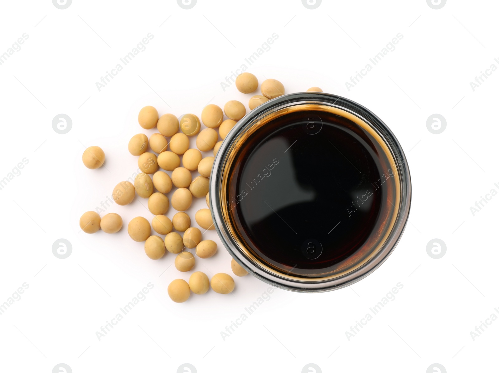 Photo of Bowl of soy sauce and soybeans isolated on white, top view