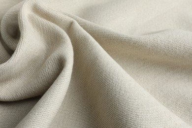 Photo of Texture of beige crumpled fabric as background, closeup